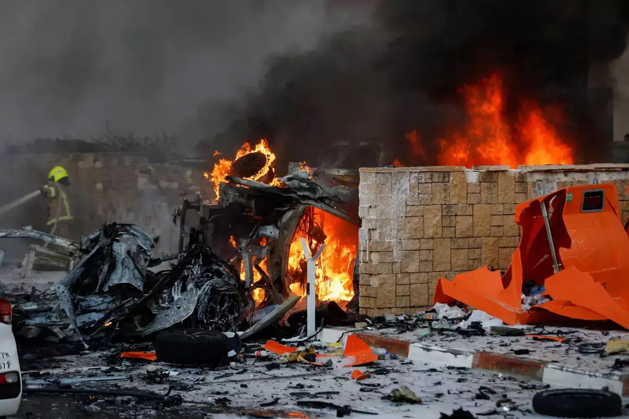 Objects burn on a road after rockets were launched from the Gaza Strip, in Ashkelon, Israel. Photo: Amir Cohen/Reuters