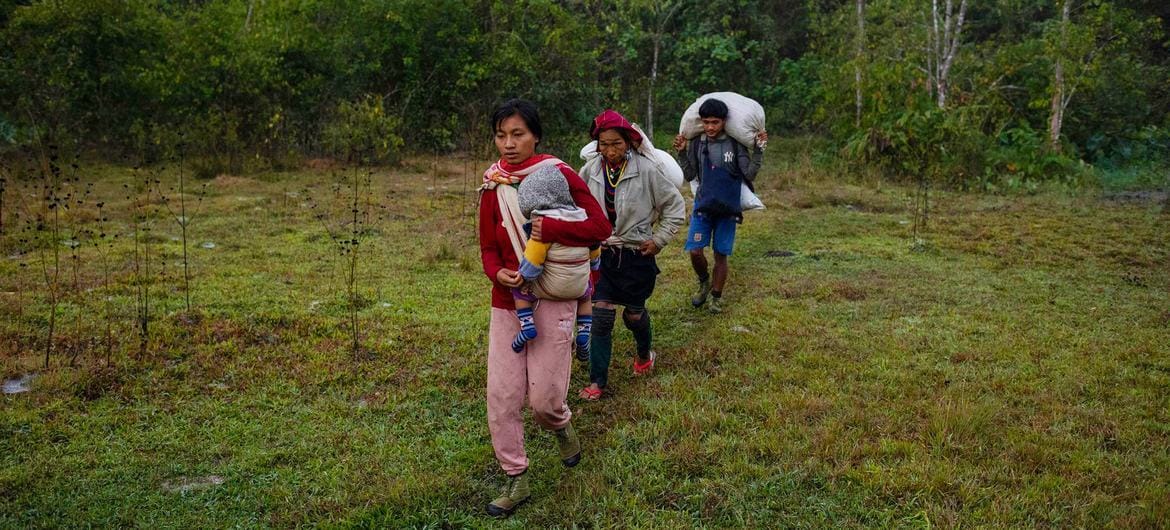 A family walks through Kayah State, in southeastern on their way to safety across the border to Thailand. Photo: Siegfried Modola/UNOCHA
